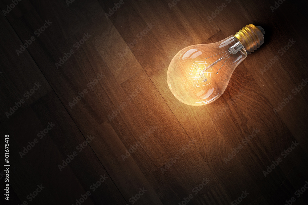 Light bulb on wooden surface Light bulb on wooden surface