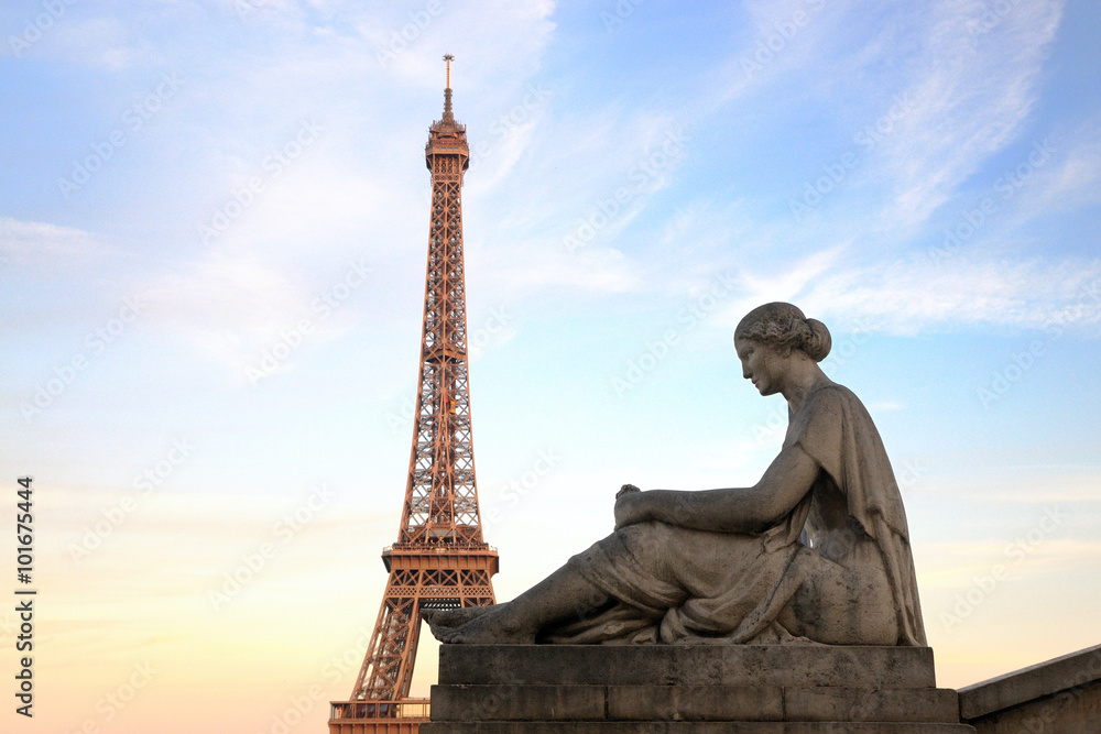 Eiffel Tower from Trocadero with statue of woman, at sunset