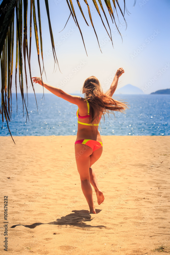 blonde slim gymnast in bikini backside runs to sea hands up Stock Photo |  Adobe Stock