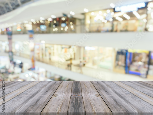 Wooden board empty table blurred background. Perspective brown wood over blur in department store - can be used for display or montage your products.Mock up for display of product. © tirachard