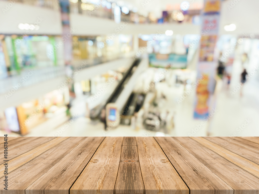 Wooden board empty table blurred background. Perspective brown wood over blur in department store - can be used for display or montage your products.Mock up for display of product.