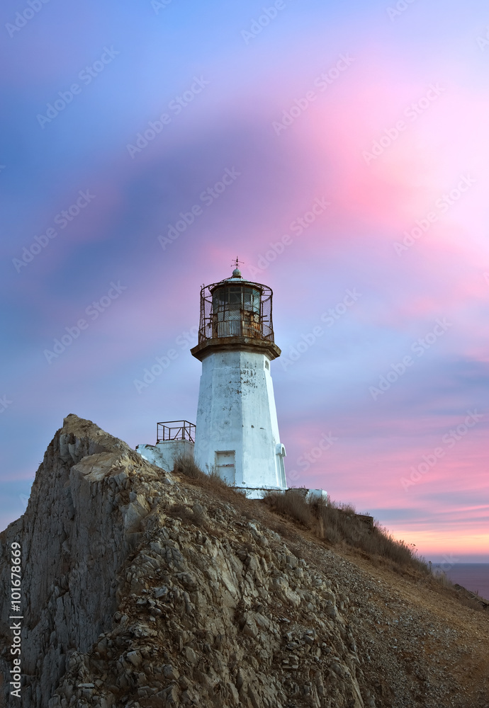 Lighthouse on a high cliff on the coast.