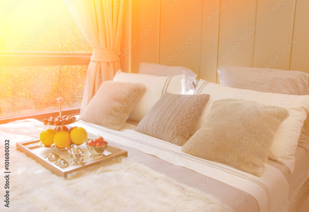 wooden tray with fresh fruits on bed