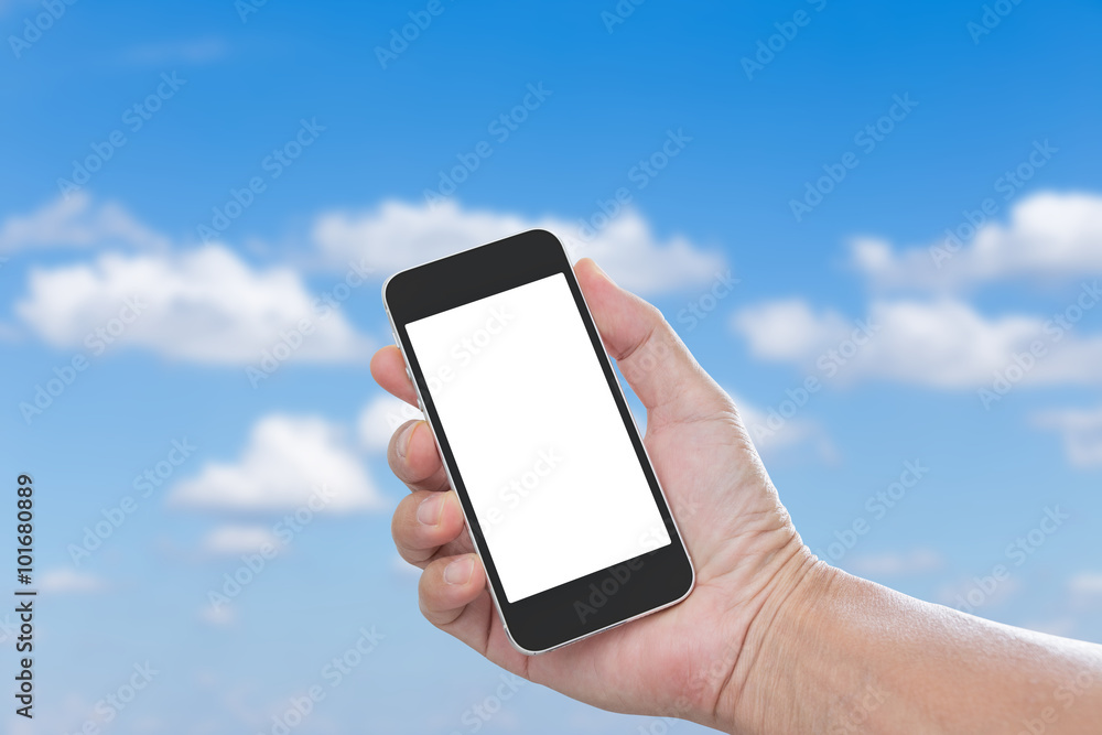 Hand holding blank screen mobile phone with blue sky background