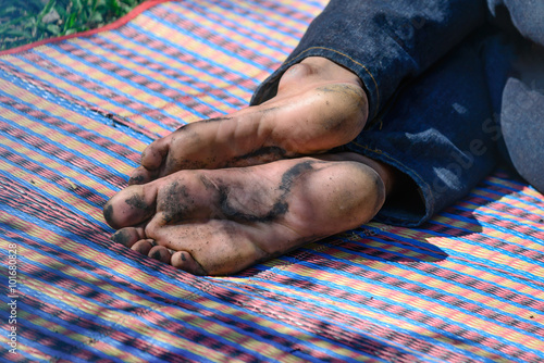Closeup of Homeless people's foots sleeping at streetside in cit