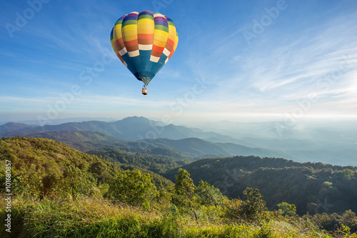 Hot air balloon above high mountain at sunset © littlestocker