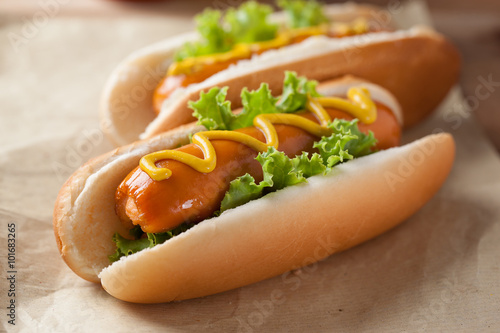 hot dogs with mustard on paper for lunch photo