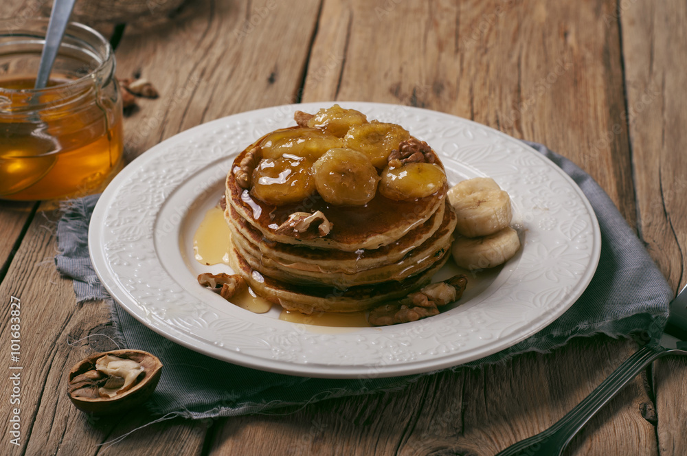 Homemade pancake with honey, nuts and caramelized bananas Homemade pancake with honey, nuts and caramelized bananas