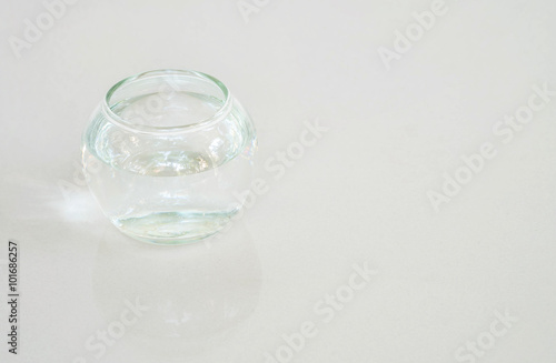 Closeup glass cup with water on gray marble stone floor background