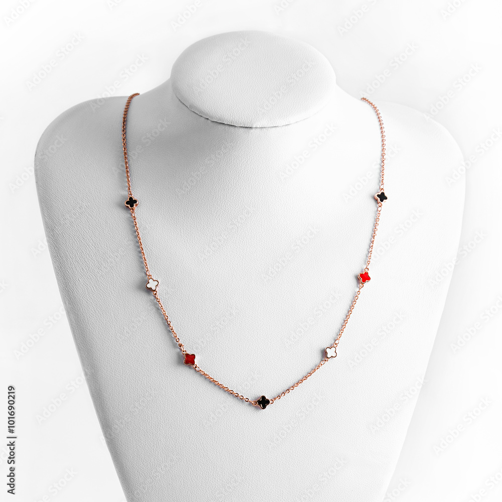 Necklace made of gold on white stand. Luxury women accessories. Necklace made of gold on white stand. Luxury women accessories.