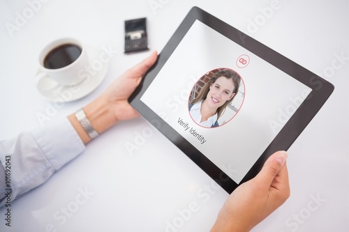 Composite image of man using tablet pc photo