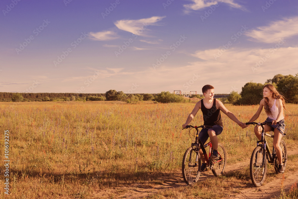 Fototapeta premium young couple having a bike ride in nature
