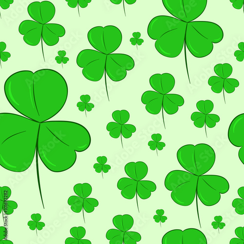 Seamless shamrocks on green photo