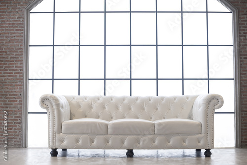 White leather sofa with white background window in vintage room