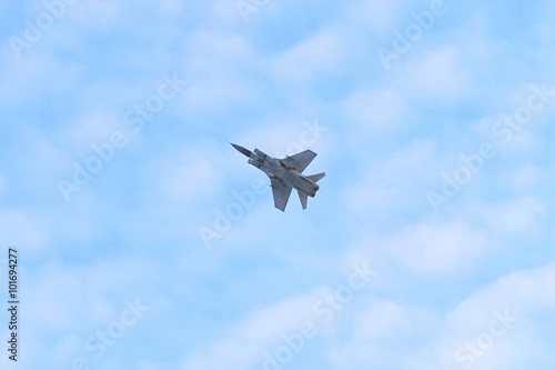 Russian military aircraft MiG-29 flies in blue sky 