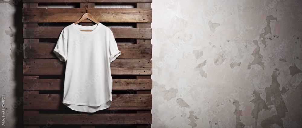 Photo white tshirt  hanging in front of concrete wall. Wide - obrazy, fototapety, plakaty 