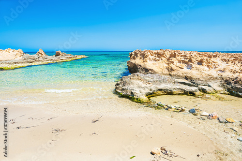 Beautiful wild beach with clear turquoise water and white sand.