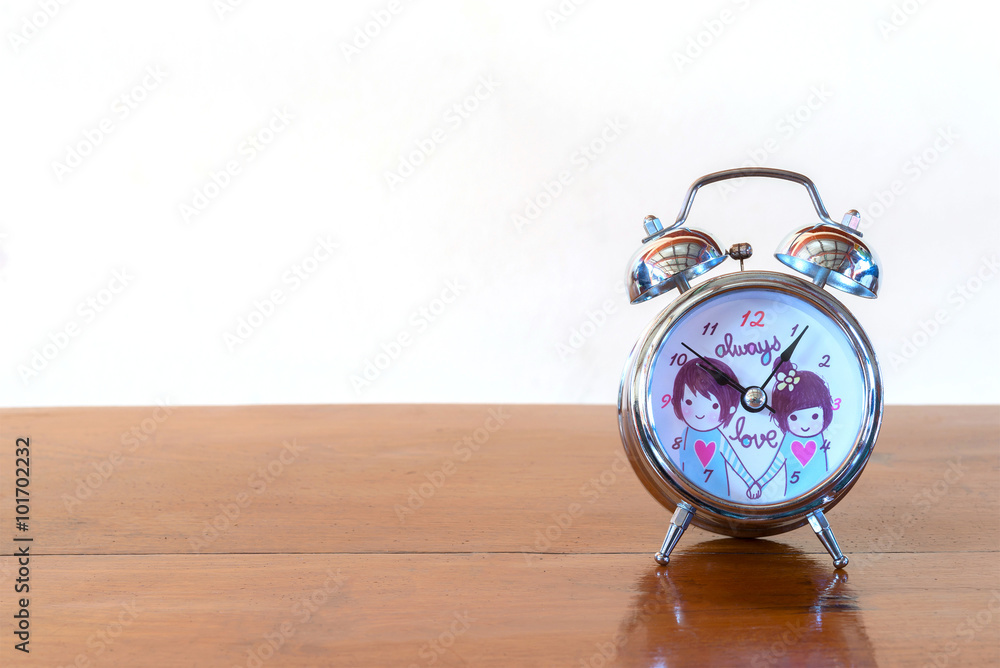 Clock on wooden table front mint cream background Clock on wooden table front mint cream background
