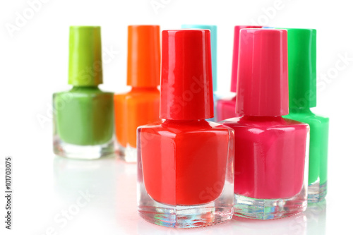 Nail Polish on white isolated background.Photo from a large number of glass bottles with colored lacquer