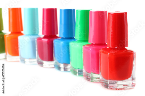 Nail Polish on white isolated background.Photo from a large number of glass bottles with colored lacquer