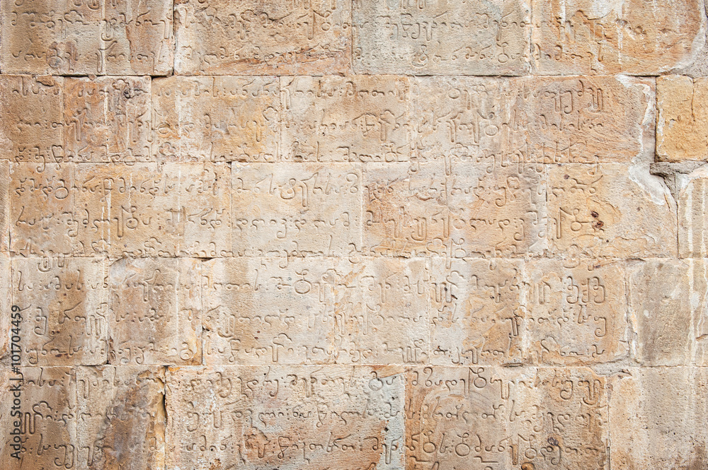 Fototapeta premium ancient brick wall with georgian letters