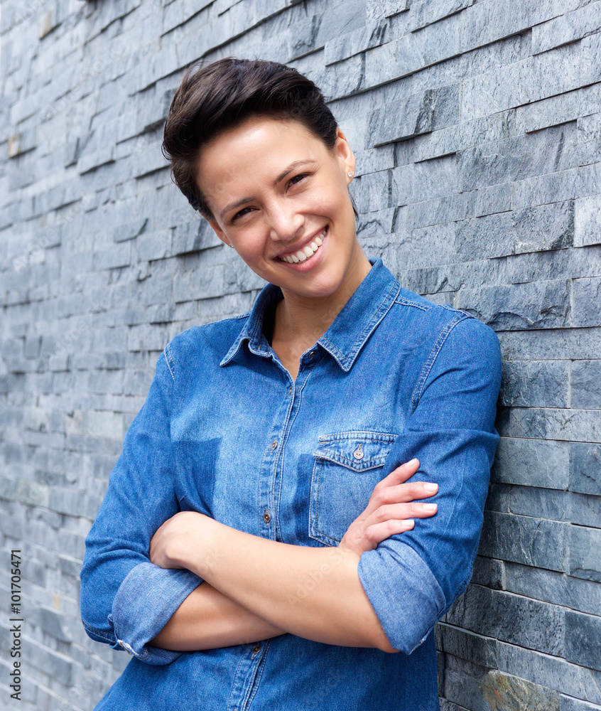 Cool young woman smiling against gray background Cool young woman smiling against gray background