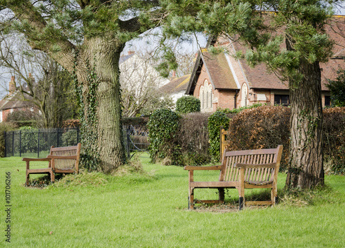 Benches Under Trees on a Village Green in Kent photo