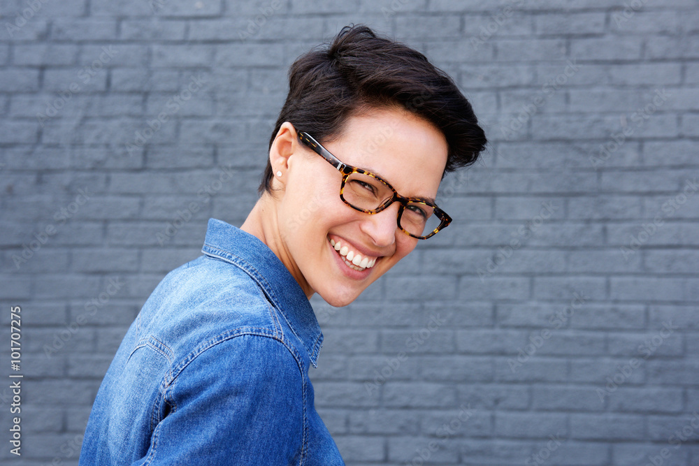 Attractive young woman smiling with glasses and short hair Attractive young woman smiling with glasses and short hair
