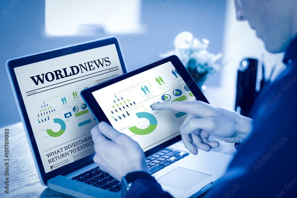 Fotografie Composite image of businessman using tablet computer in office