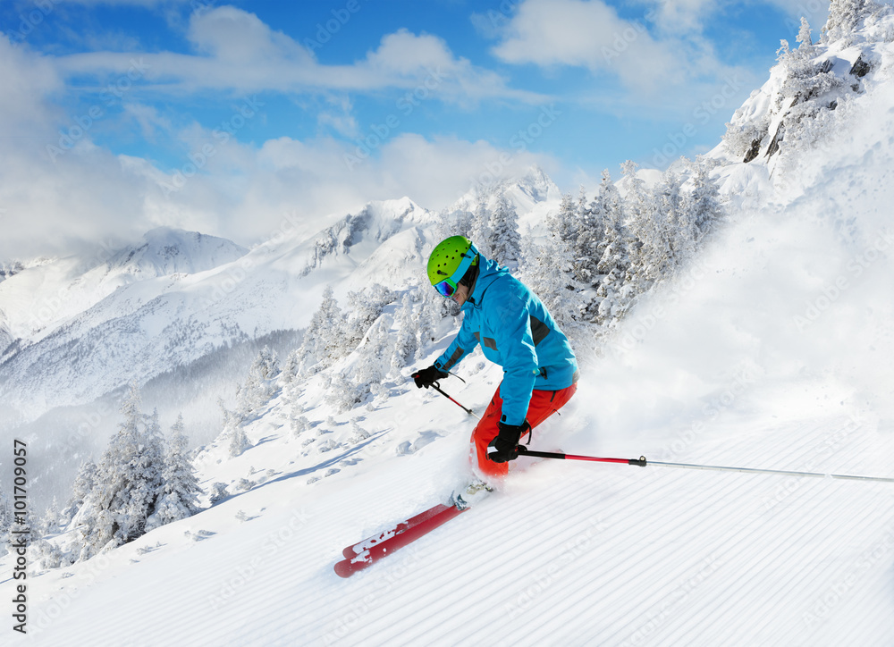 Man skier running downhill