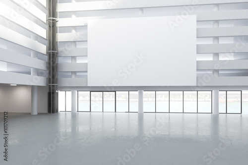 Blank white billboard in the hall of empty building with concret