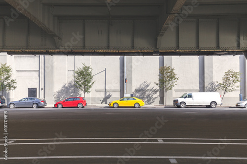 Cars parked on the street under overpass in Manhattan, NYC