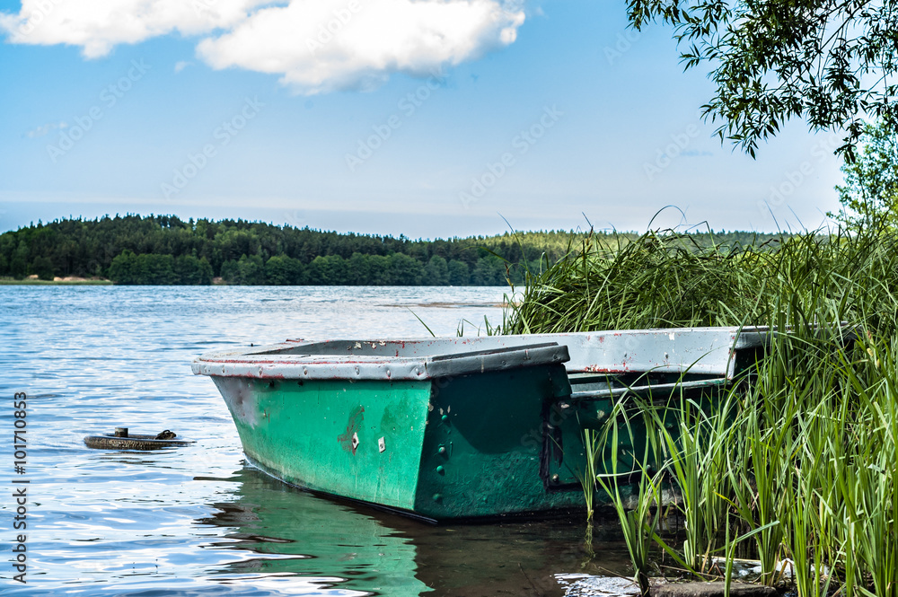 Landscape with boat on the lake shore Landscape with boat on the lake shore