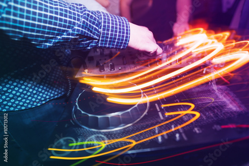 Club DJ playing mixing music on vinyl turntable