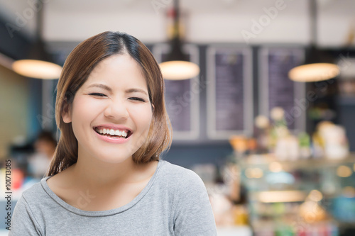 happy self-employed woman with bakery shop background