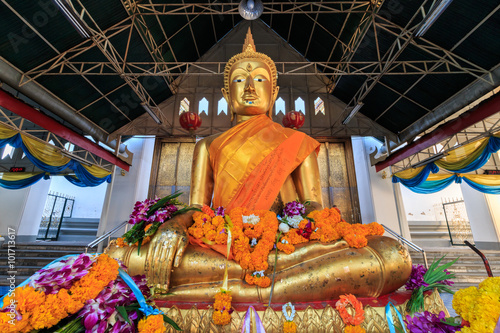 Golden Buddha statue in Thai  Buddhist Temple locally know as Wat Kalayanamitr Varamahavihara , Bangkok Thailand photo