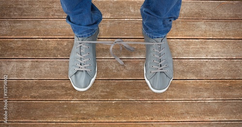 Composite image of man with shoelaces tied together