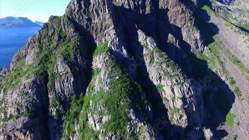 Aerial view of rocky mountain face on Lofoten islands in Norway, popular destination for climbers, on sunny summer day. Aerial 4k Ultra HD.