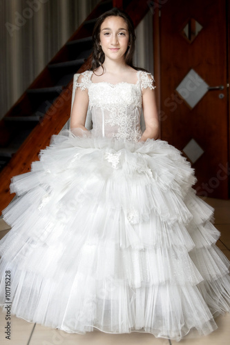 Girl dressed as a first communion at home