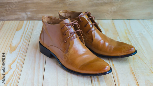 classic brown oxford shoes on wooden background