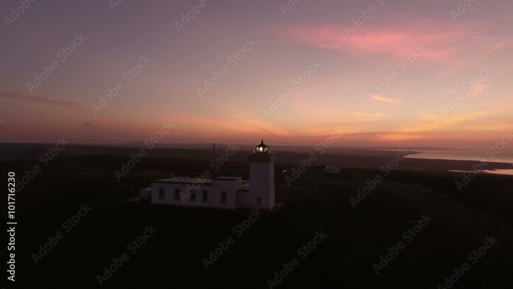 Drone shot of Duncansby Head lighthouse with rotating light near John O' Groats in Scotland during sunset
Drone shot of Duncansby Head lighthouse with rotating light near John O' Groats in Scotland during sunset