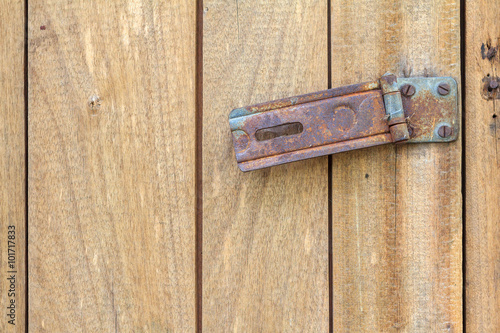 Rusty hinge Lock on old wooden door.