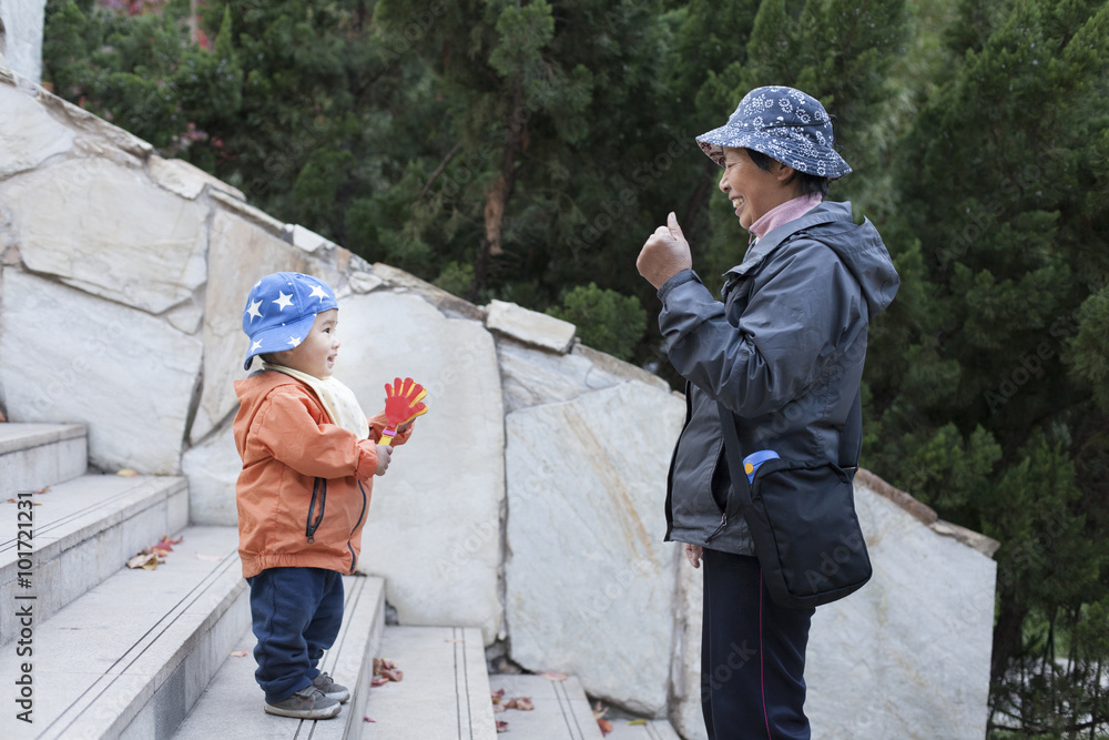 Chinese grandmother and grandson playing on stairs Chinese grandmother and grandson playing on stairs