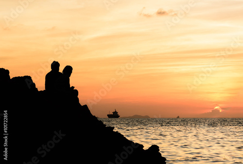 Silhouette of a couple watching a colorful sunset