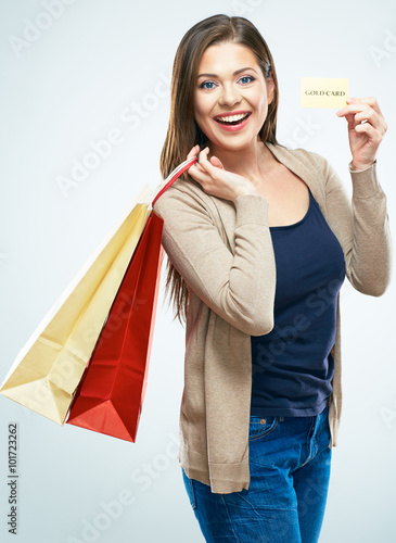 Shopping with credit card. Smiling woman standing with shopping photo