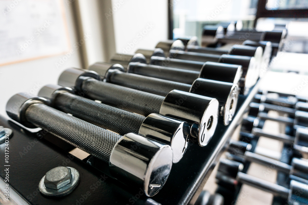 Naklejka premium Row of dumbbells in gym.