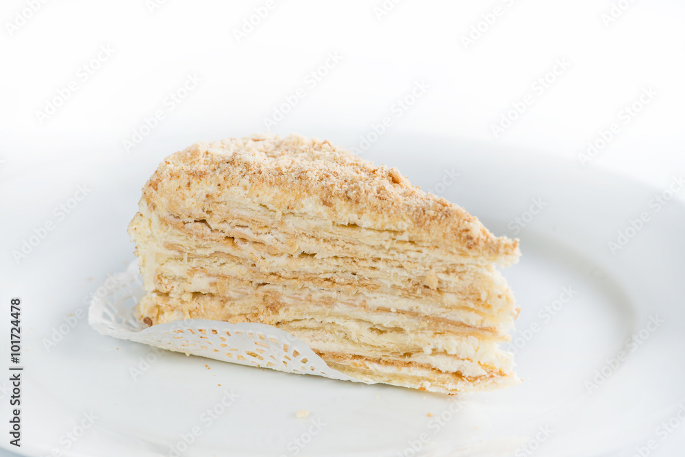 Delicious cake on plate on table on light background (shallow D Delicious cake on plate on table on light background (shallow D