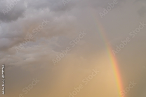 colorful rainbow on rain cloud sunset sky