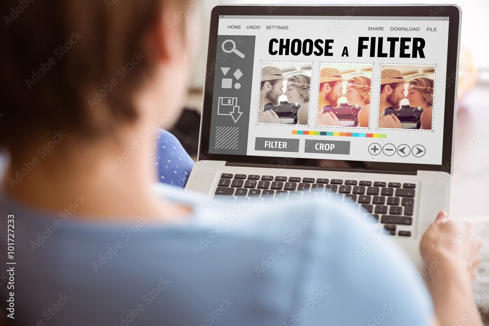 Fotografie Composite image of pregnant woman using her laptop