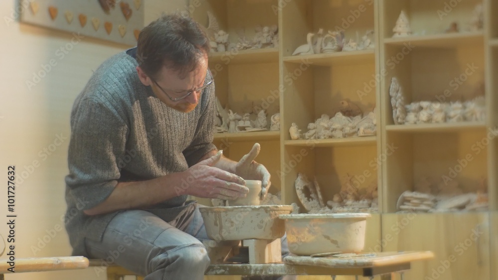 Man is Molding a Clay Pot by Hands Then Takes Spatula Continue to Mold His Souvenir Working on a Pottery Wheel Rotating a Wheel Pottery Workshop Man is Molding a Clay Pot by Hands Then Takes Spatula Continue to Mold His Souvenir Working on a Pottery Wheel Rotating a Wheel Pottery Workshop